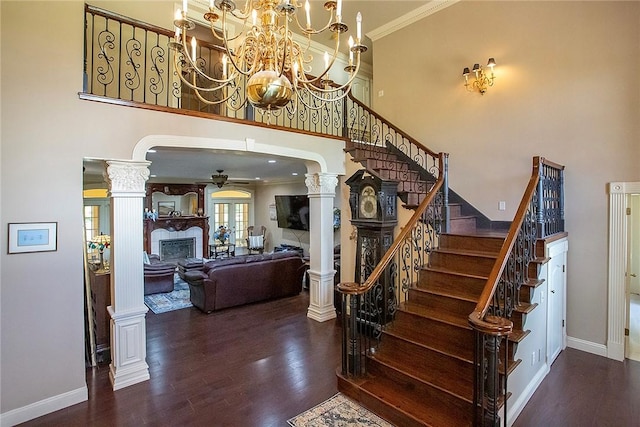 1060 Marina Way, Russellville, AR 72801 - stairway with a towering ceiling, a fireplace, ceiling fan, wood finished floors, and baseboards