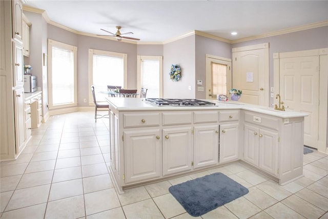 1060 Marina Way, Russellville, AR 72801 - kitchen with stainless steel gas cooktop, light countertops, a ceiling fan, light tile patterned floors, and white microwave