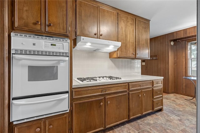 5 Rolling Meadows Dr, Harrison, AR 72601 - kitchen with a warming drawer, under cabinet range hood, white appliances, decorative backsplash, and light countertops
