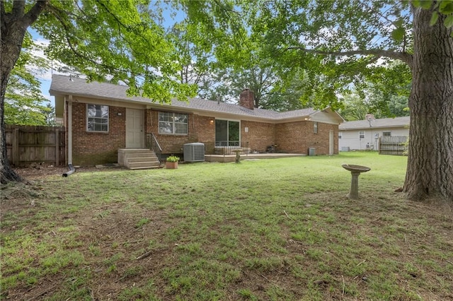 5 Rolling Meadows Dr, Harrison, AR 72601 - rear view of house with brick siding, central AC unit, and a chimney