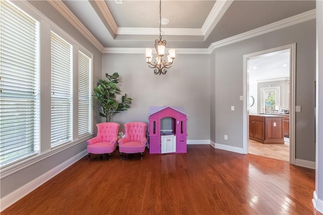2314 S The Peaks Blvd, Rogers, AR 72758 - living area featuring a tray ceiling, light wood-style flooring, a chandelier, baseboards, and ornamental molding