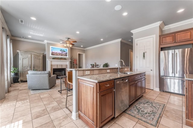 2314 S The Peaks Blvd, Rogers, AR 72758 - kitchen with stainless steel appliances, a sink, recessed lighting, a ceiling fan, and a tiled fireplace
