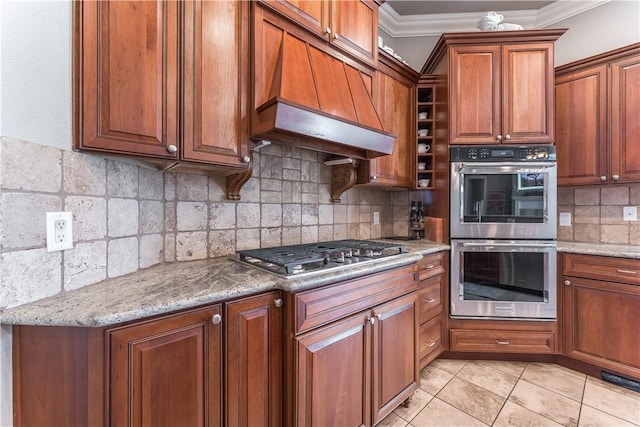 2314 S The Peaks Blvd, Rogers, AR 72758 - kitchen featuring stainless steel appliances, custom range hood, ornamental molding, backsplash, and brown cabinets