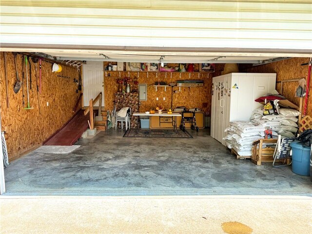 15829 N Wimpy Jones Rd, Garfield, AR 72732 - garage featuring electric panel, a workshop area, and wood walls