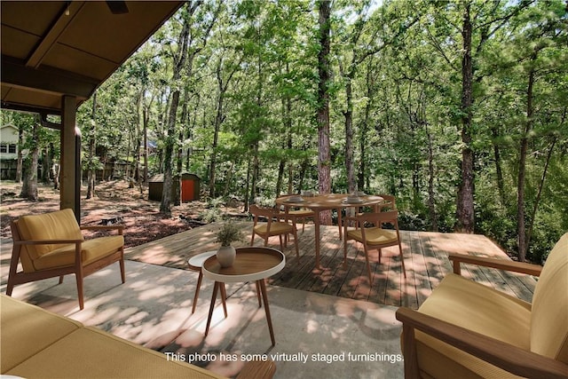 1463 E Woodbrook Dr, Fayetteville, AR 72703 - view of patio / terrace featuring outdoor dining space, a wooded view, and a deck
