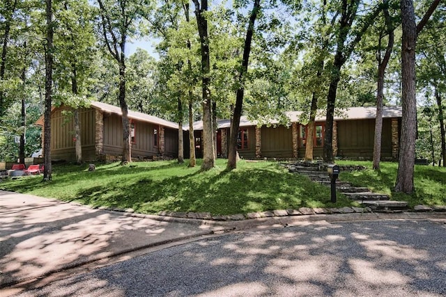1463 E Woodbrook Dr, Fayetteville, AR 72703 - view of front facade featuring stone siding, a front yard, and board and batten siding