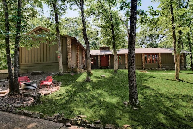 1463 E Woodbrook Dr, Fayetteville, AR 72703 - view of front of home featuring a front lawn and board and batten siding