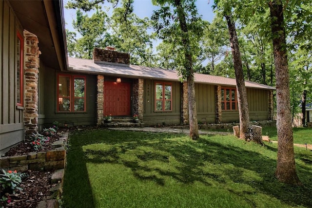 1463 E Woodbrook Dr, Fayetteville, AR 72703 - view of front of home featuring a chimney, a front lawn, and board and batten siding