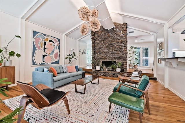 1463 E Woodbrook Dr, Fayetteville, AR 72703 - living room featuring wood finished floors, a stone fireplace, and baseboards