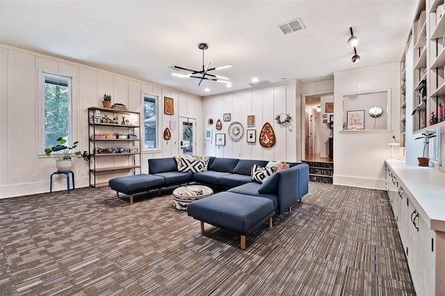 1463 E Woodbrook Dr, Fayetteville, AR 72703 - living area with dark carpet, a decorative wall, and baseboards