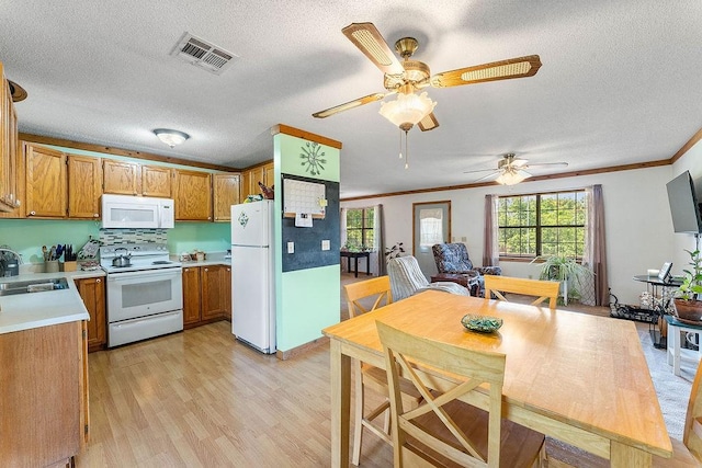 1188 Kyle Rd, Noel, MO 64854 - kitchen featuring white appliances, plenty of natural light, light wood-type flooring, light countertops, and ornamental molding