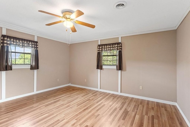 1188 Kyle Rd, Noel, MO 64854 - empty room featuring light wood-style flooring, plenty of natural light, baseboards, a ceiling fan, and crown molding