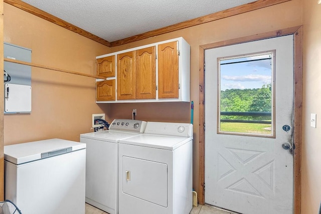 1188 Kyle Rd, Noel, MO 64854 - laundry area with washing machine and clothes dryer, cabinet space, ornamental molding, and a textured ceiling