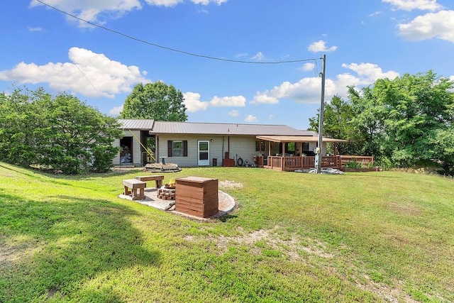1188 Kyle Rd, Noel, MO 64854 - rear view of house featuring a fire pit, a yard, a deck, and metal roof