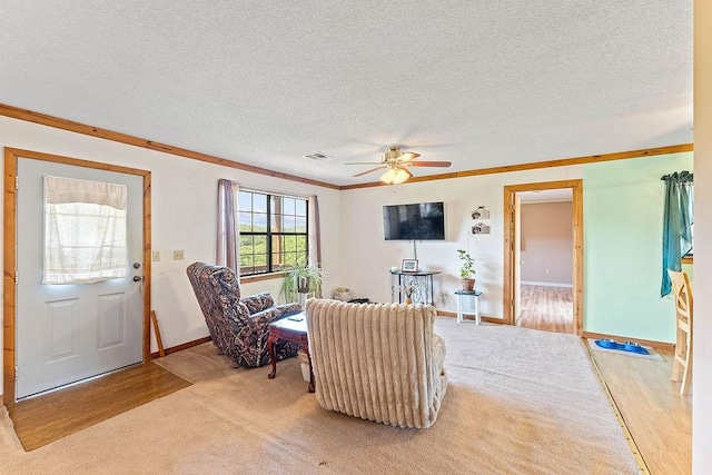 1188 Kyle Rd, Noel, MO 64854 - living area featuring crown molding, a ceiling fan, a textured ceiling, baseboards, and light wood finished floors