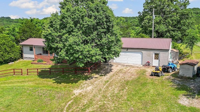 1188 Kyle Rd, Noel, MO 64854 - rear view of house with an outdoor structure, metal roof, driveway, and a garage
