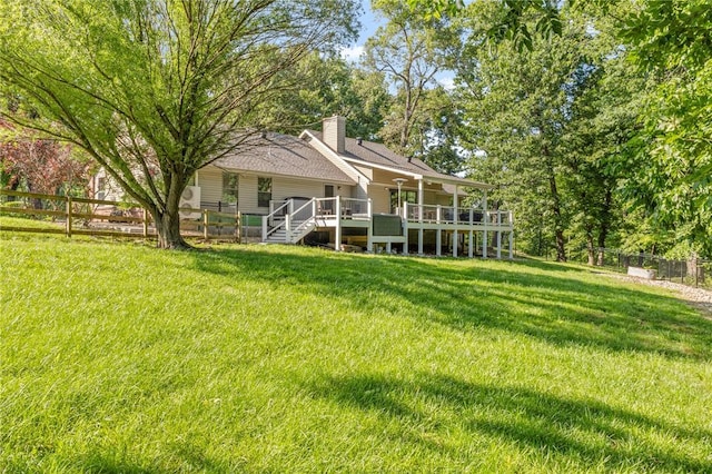 3307 NW 3rd St, Bentonville, AR 72712 - rear view of house featuring a chimney and a wooden deck
