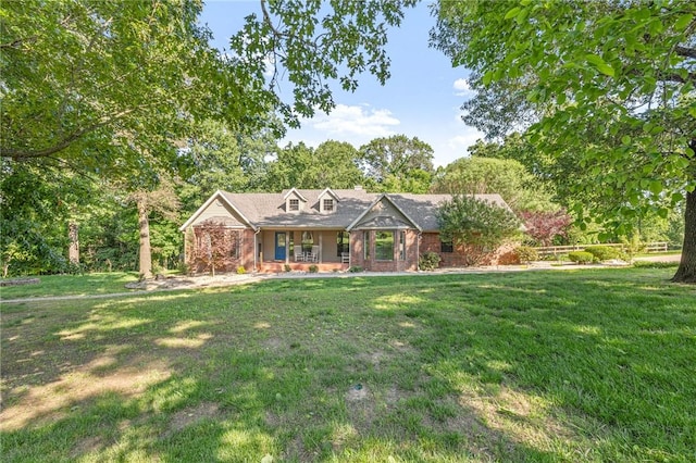 3307 NW 3rd St, Bentonville, AR 72712 - view of front of home with a front yard, covered porch, and brick siding
