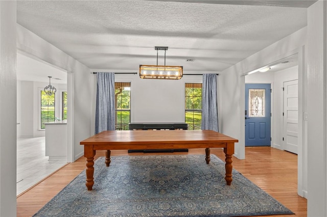 3307 NW 3rd St, Bentonville, AR 72712 - home office with light wood-style floors, a textured ceiling, and a chandelier