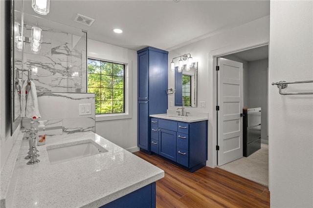 3307 NW 3rd St, Bentonville, AR 72712 - full bathroom featuring vanity, wood finished floors, a marble finish shower, recessed lighting, and baseboards