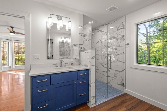 3307 NW 3rd St, Bentonville, AR 72712 - full bath with a marble finish shower, vanity, wood finished floors, and ceiling fan