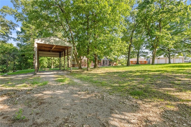 3307 NW 3rd St, Bentonville, AR 72712 - view of green lawn with a detached carport, an outdoor structure, and a pole building