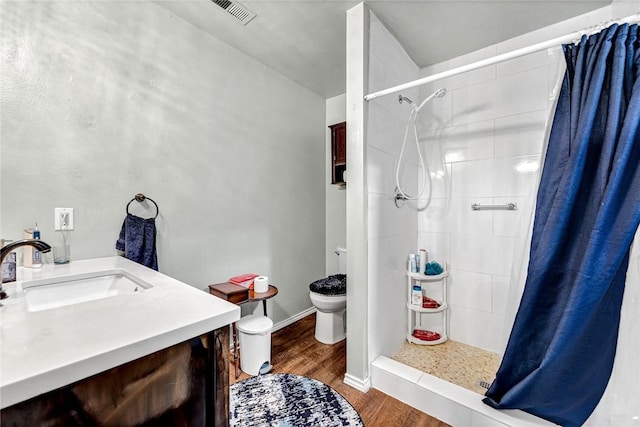 64 Cheryl Cir, Bentonville, AR 72712 - bathroom featuring toilet, wood finished floors, a stall shower, and vanity