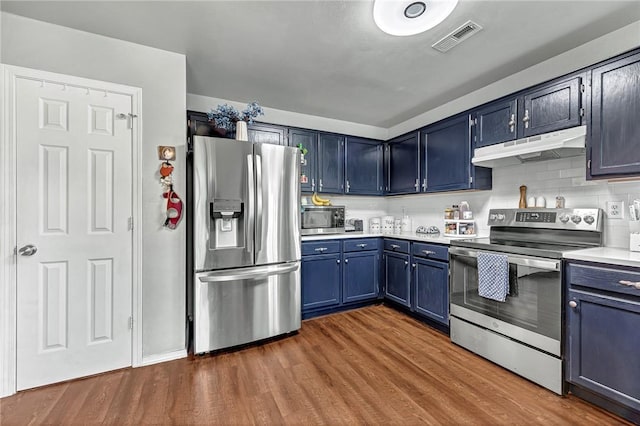 64 Cheryl Cir, Bentonville, AR 72712 - kitchen featuring appliances with stainless steel finishes, under cabinet range hood, blue cabinetry, and dark wood-style flooring