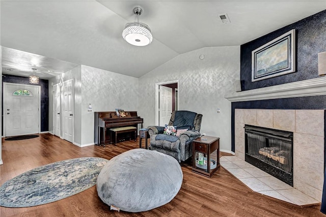 64 Cheryl Cir, Bentonville, AR 72712 - sitting room featuring lofted ceiling, wood finished floors, a fireplace, baseboards, and a textured wall
