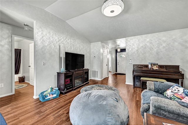 64 Cheryl Cir, Bentonville, AR 72712 - living room with vaulted ceiling, wood finished floors, and baseboards