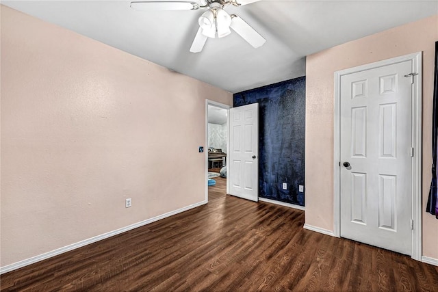 64 Cheryl Cir, Bentonville, AR 72712 - unfurnished bedroom with wood finished floors, baseboards, and ceiling fan