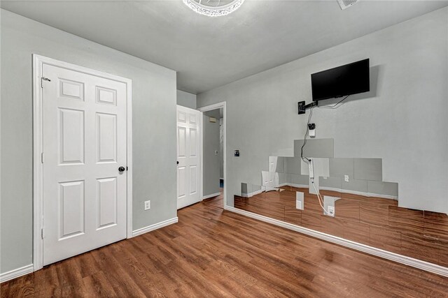 64 Cheryl Cir, Bentonville, AR 72712 - unfurnished bedroom with wood finished floors and baseboards