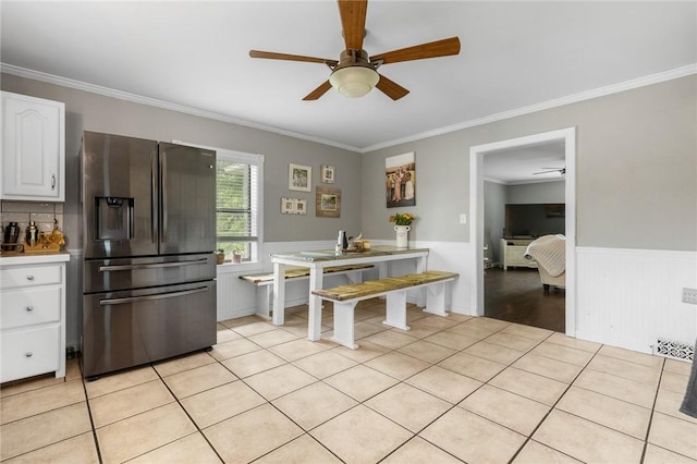 4220 S 7th Hwy, Harrison, AR 72601 - kitchen featuring stainless steel refrigerator with ice dispenser, a ceiling fan, wainscoting, white cabinetry, and ornamental molding