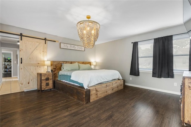 4220 S 7th Hwy, Harrison, AR 72601 - bedroom featuring a barn door, wood finished floors, a chandelier, and baseboards