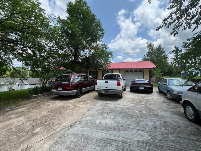 720 Circle Dr, Berryville, AR 72616 - view of front of house with an attached garage, driveway, and metal roof