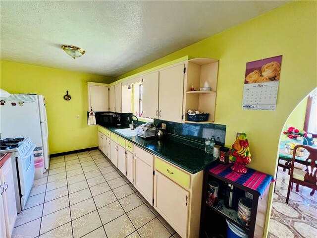 720 Circle Dr, Berryville, AR 72616 - kitchen with white appliances, a sink, open shelves, dark countertops, and white cabinetry