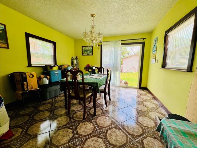 720 Circle Dr, Berryville, AR 72616 - dining room featuring a chandelier and a textured ceiling