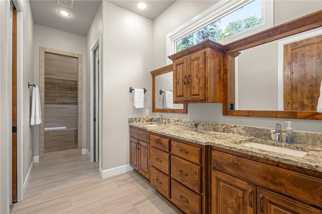 42 Devizis Dr, Bella Vista, AR 72714 - full bathroom with double vanity, baseboards, tiled shower, and recessed lighting