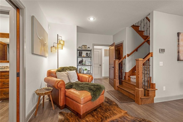 42 Devizis Dr, Bella Vista, AR 72714 - sitting room with stairs, wood finished floors, baseboards, and recessed lighting