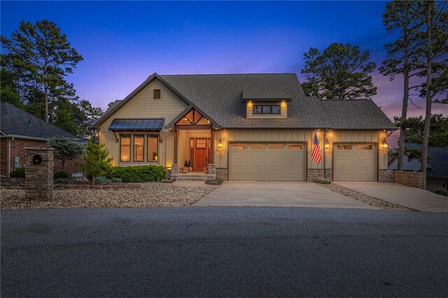 42 Devizis Dr, Bella Vista, AR 72714 - view of front of property featuring driveway, board and batten siding, a garage, a shingled roof, and stone siding