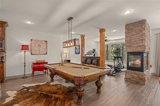 42 Devizis Dr, Bella Vista, AR 72714 - playroom featuring wood finished floors, baseboards, pool table, recessed lighting, and a fireplace
