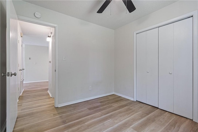 3021-3023 N Old Missouri Rd, Fayetteville, AR 72703 - unfurnished bedroom with wood finished floors, a closet, a ceiling fan, and baseboards