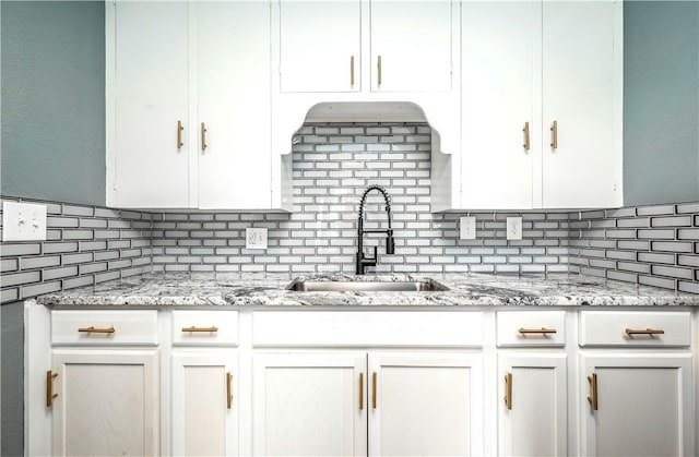 2532 E 4th St, Tulsa, OK 74104 - kitchen featuring tasteful backsplash, a sink, white cabinetry, and light stone countertops