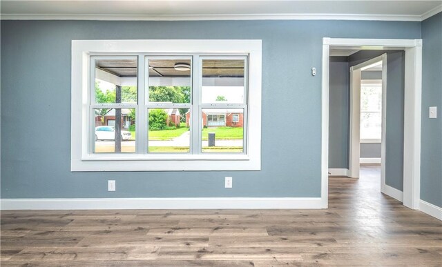 2532 E 4th St, Tulsa, OK 74104 - spare room with baseboards, ornamental molding, and wood finished floors