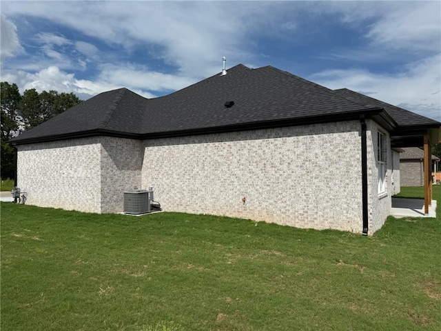 7695 Teton Trl, Springdale, AR 72762 - view of side of property with a lawn, roof with shingles, and central AC