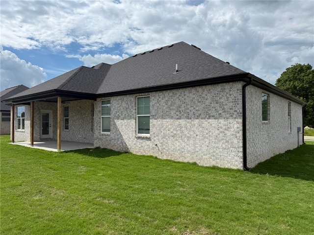 7695 Teton Trl, Springdale, AR 72762 - back of property featuring a patio, a lawn, and a shingled roof
