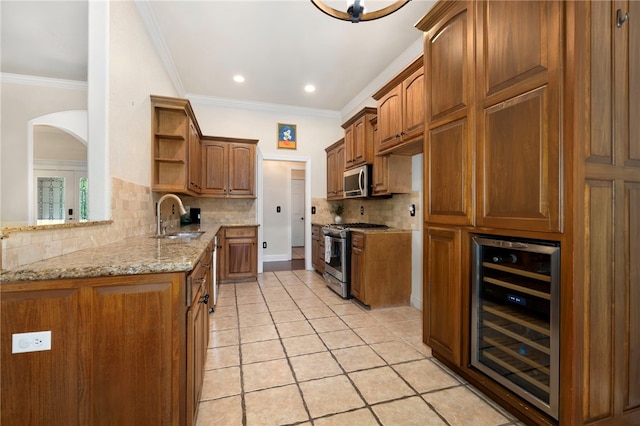 17 Webbly Ln, Bella Vista, AR 72714 - kitchen featuring wine cooler, stainless steel appliances, a sink, open shelves, and arched walkways