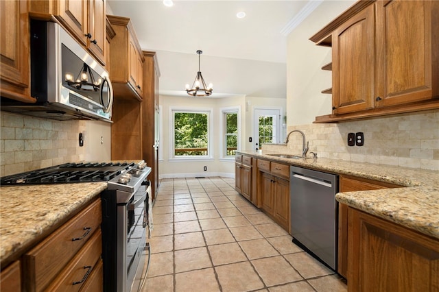 17 Webbly Ln, Bella Vista, AR 72714 - kitchen featuring appliances with stainless steel finishes, a sink, a chandelier, brown cabinets, and recessed lighting
