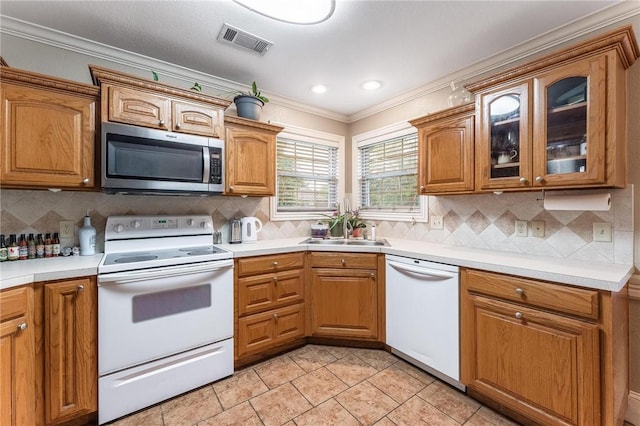 4931 Dogwood, Springdale, AR 72762 - kitchen featuring white appliances, a sink, crown molding, brown cabinets, and glass insert cabinets