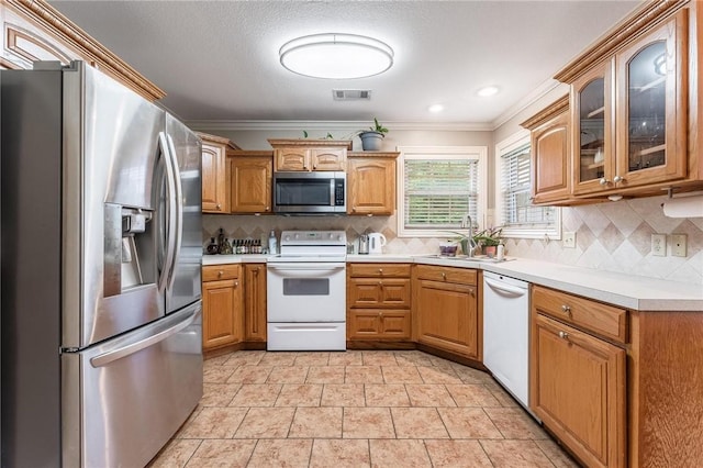 4931 Dogwood, Springdale, AR 72762 - kitchen with appliances with stainless steel finishes, a sink, crown molding, light countertops, and tasteful backsplash